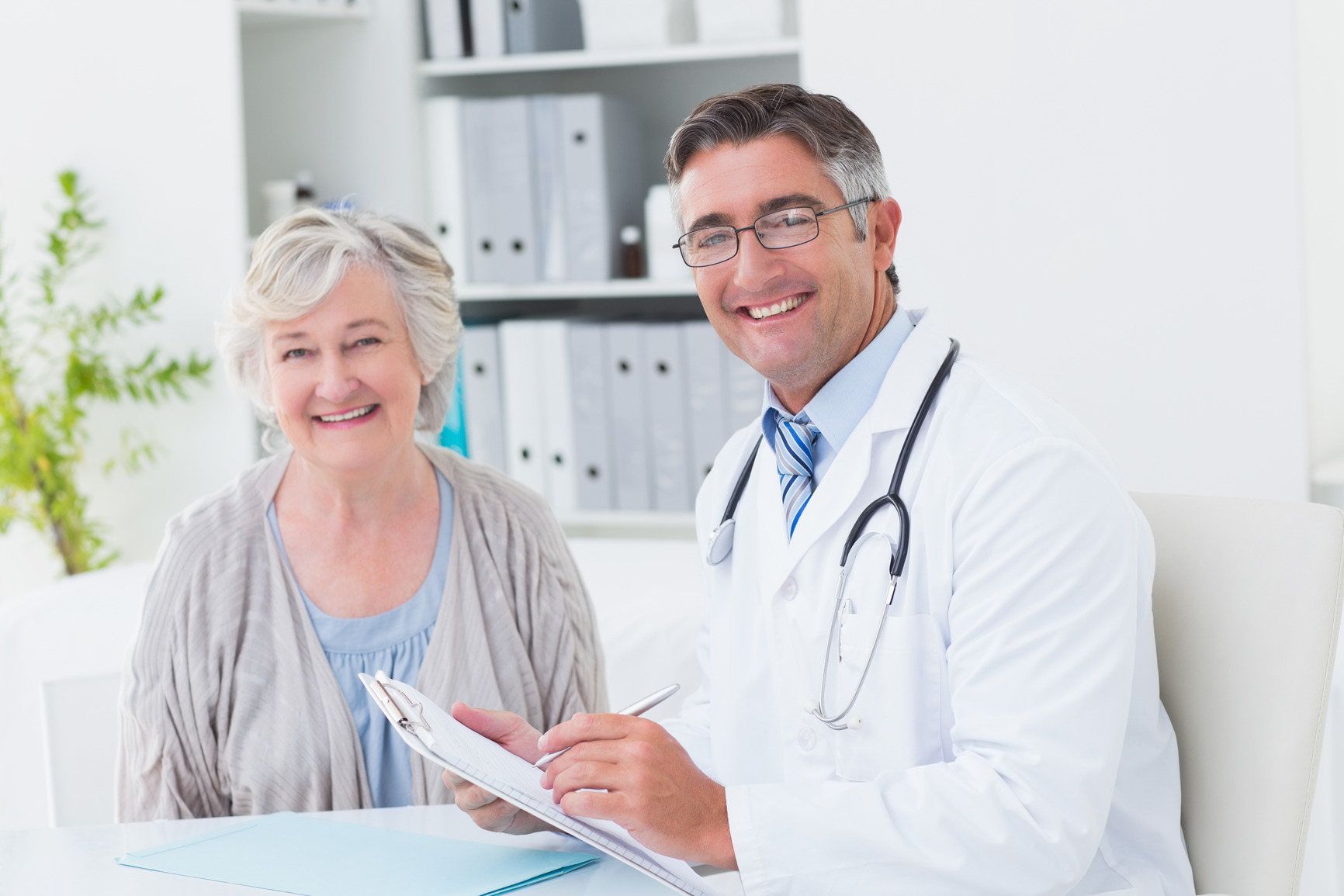 photodune-10385216-portrait-of-happy-male-doctor-and-female-patient-in-clinic-m